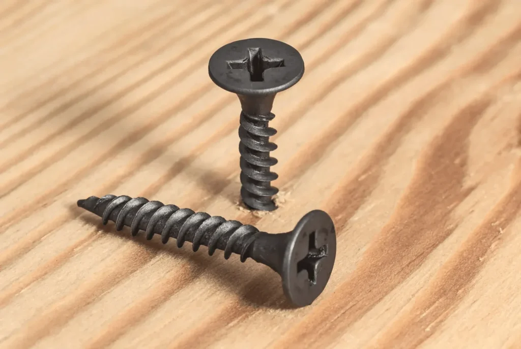 1 GYPDrive Fasteners Fasteners pair screws wooden surface close up construction repair scaled